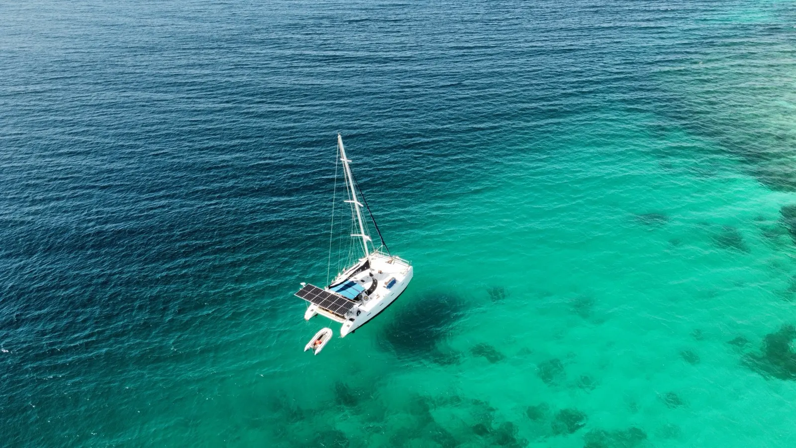 Soniya anchored with dinghy alongside over reef
