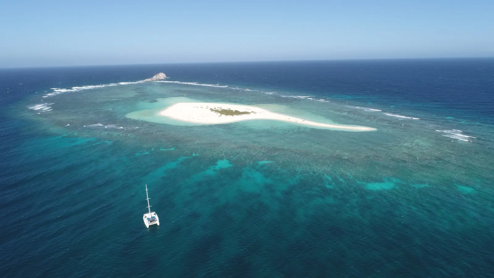 Soniya anchored beside a crescent sandbar island