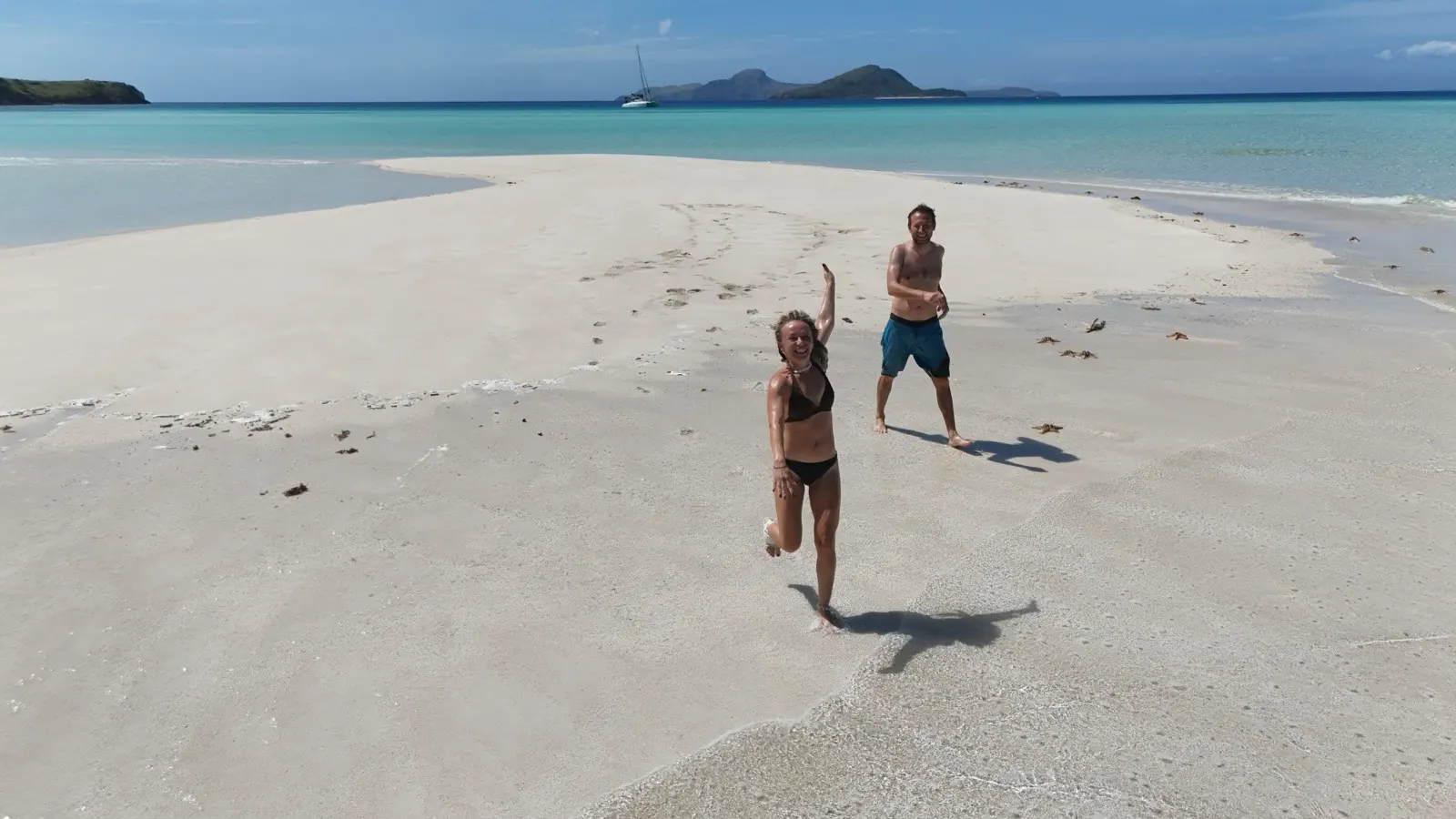 Aerial of catamaran with a kite wing floating alongside