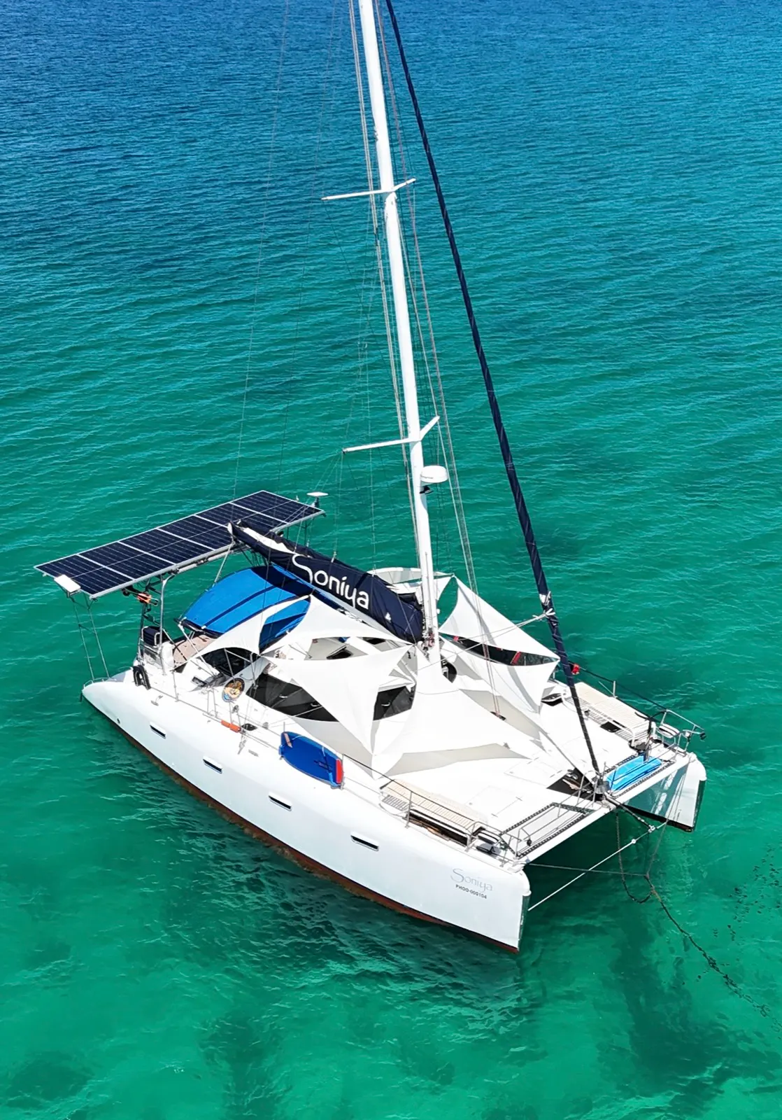 Aerial side view of catamaran under sail, rotated frame