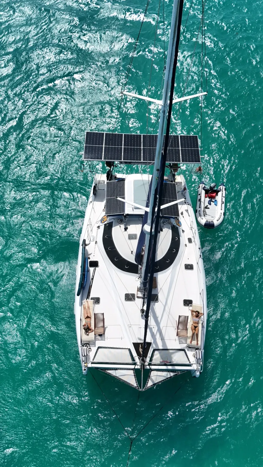 Aerial top-down of guests sunbathing on Soniya's trampolines