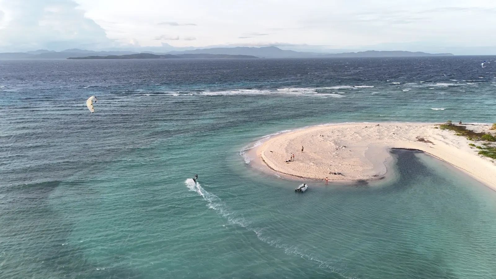 Similar sandbar aerial, two kites and people ashore
