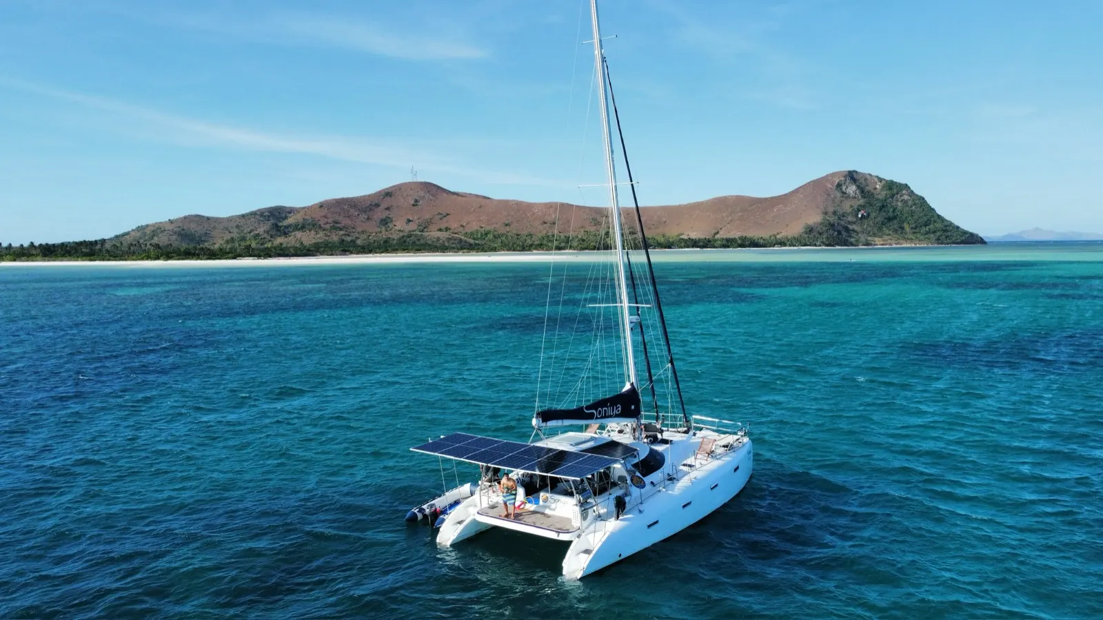 Small aerial of catamaran anchored by reef