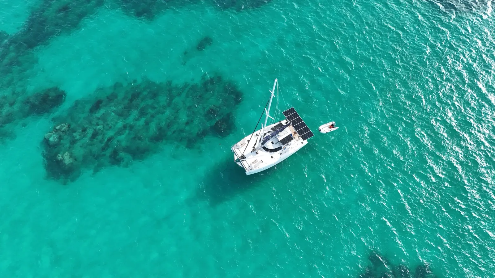 Top-down view of Soniya and dinghy over reef