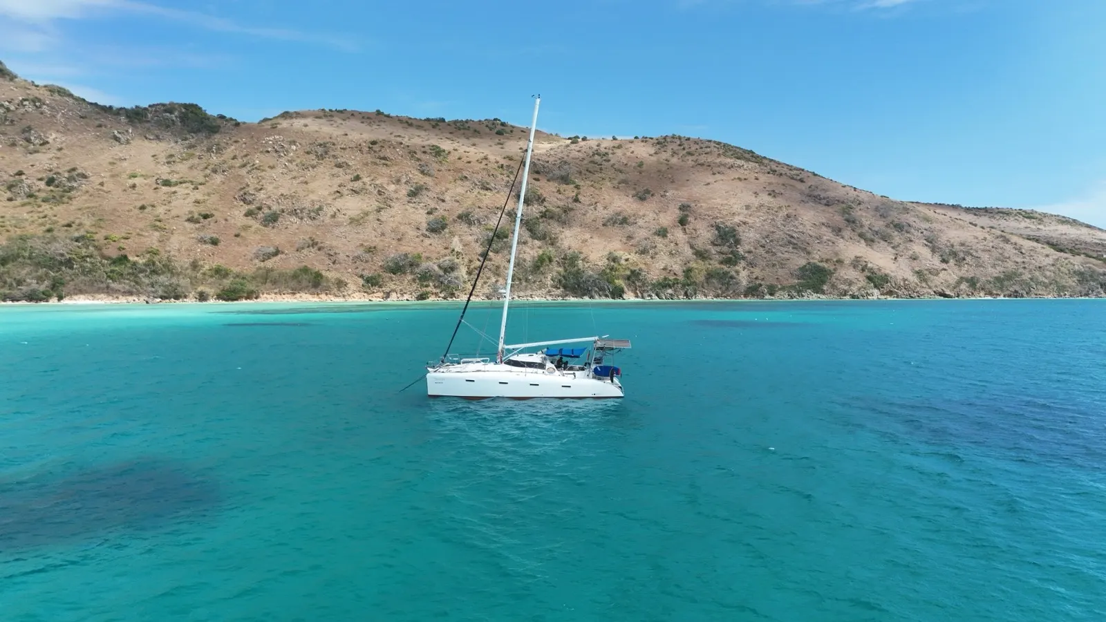 Catamaran alone at sea, side aerial view