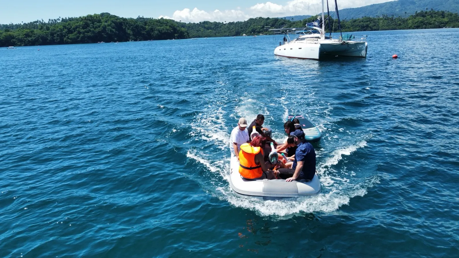 Dinghy tender full of guests in snorkel gear returning to Soniya