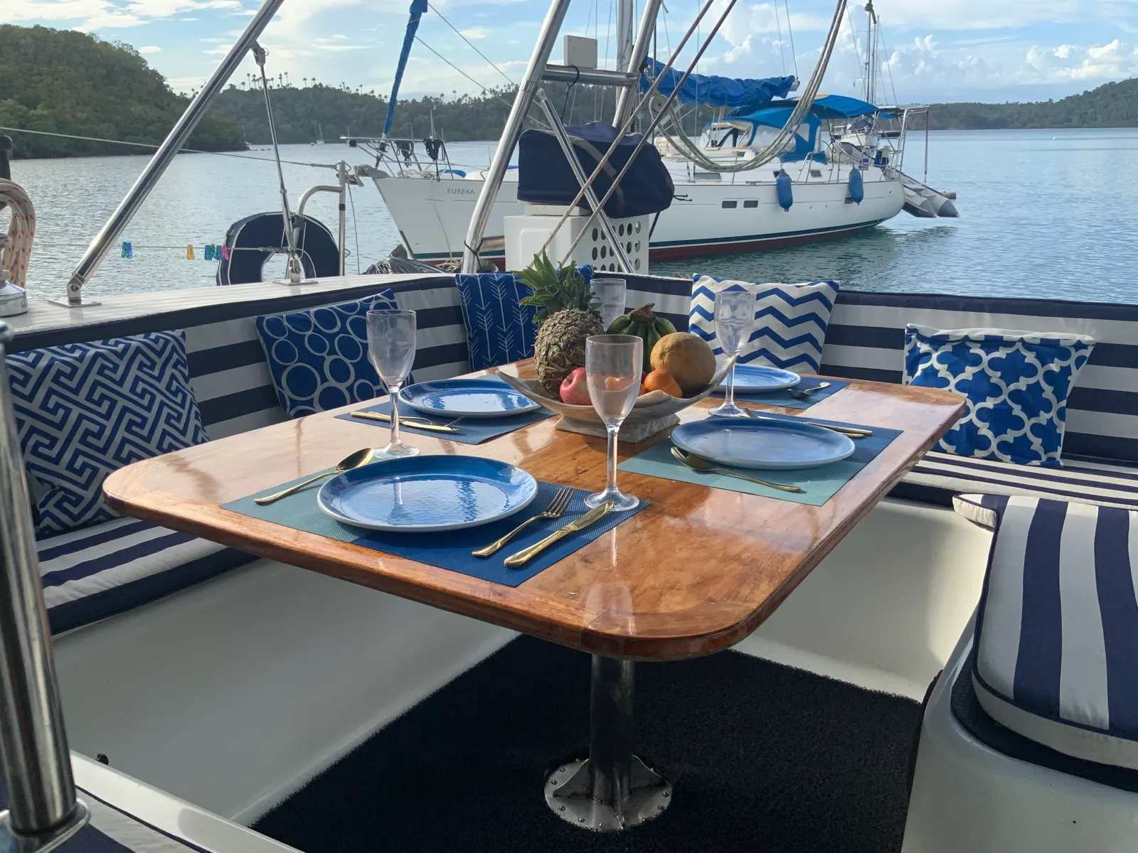 Table set for dinner with fruit bowl and wine glasses