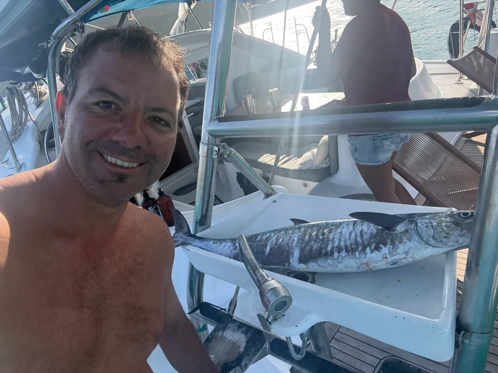 Man holding a large freshly caught barracuda/wahoo