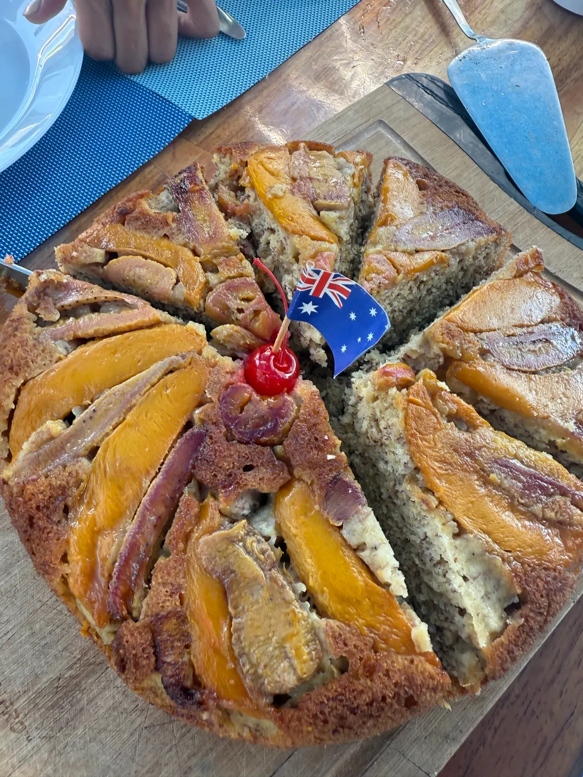 Sliced upside-down fruit cake with flag decoration