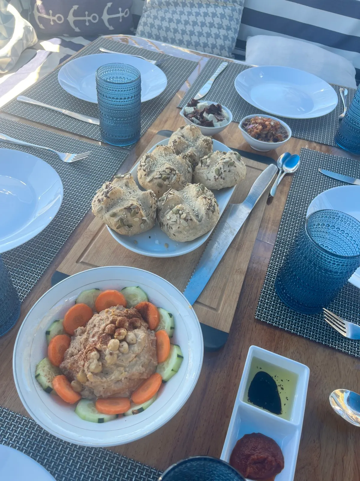 Overhead shot of table spread with bread rolls and meat dish