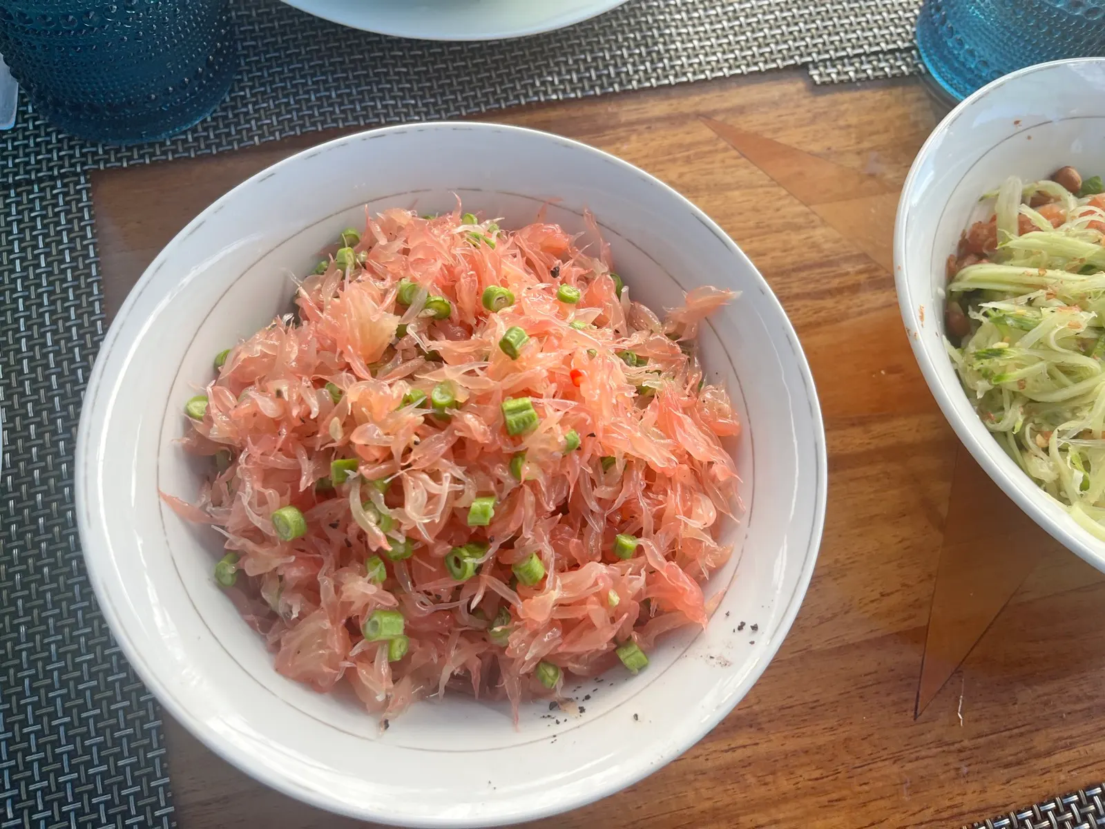 Shredded pomelo/shrimp salad in white bowl
