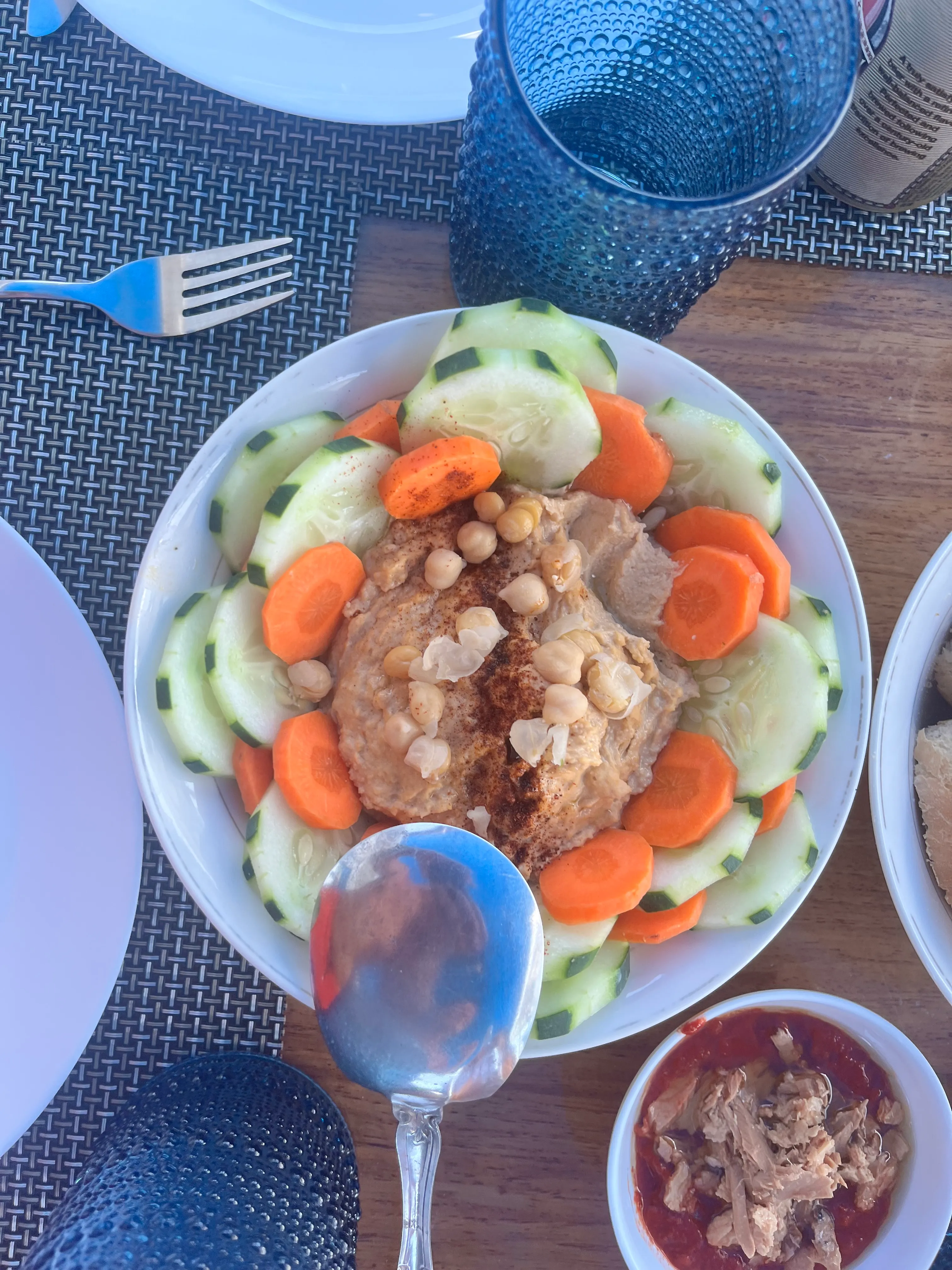 Hummus plate with cucumber, carrot, and tuna