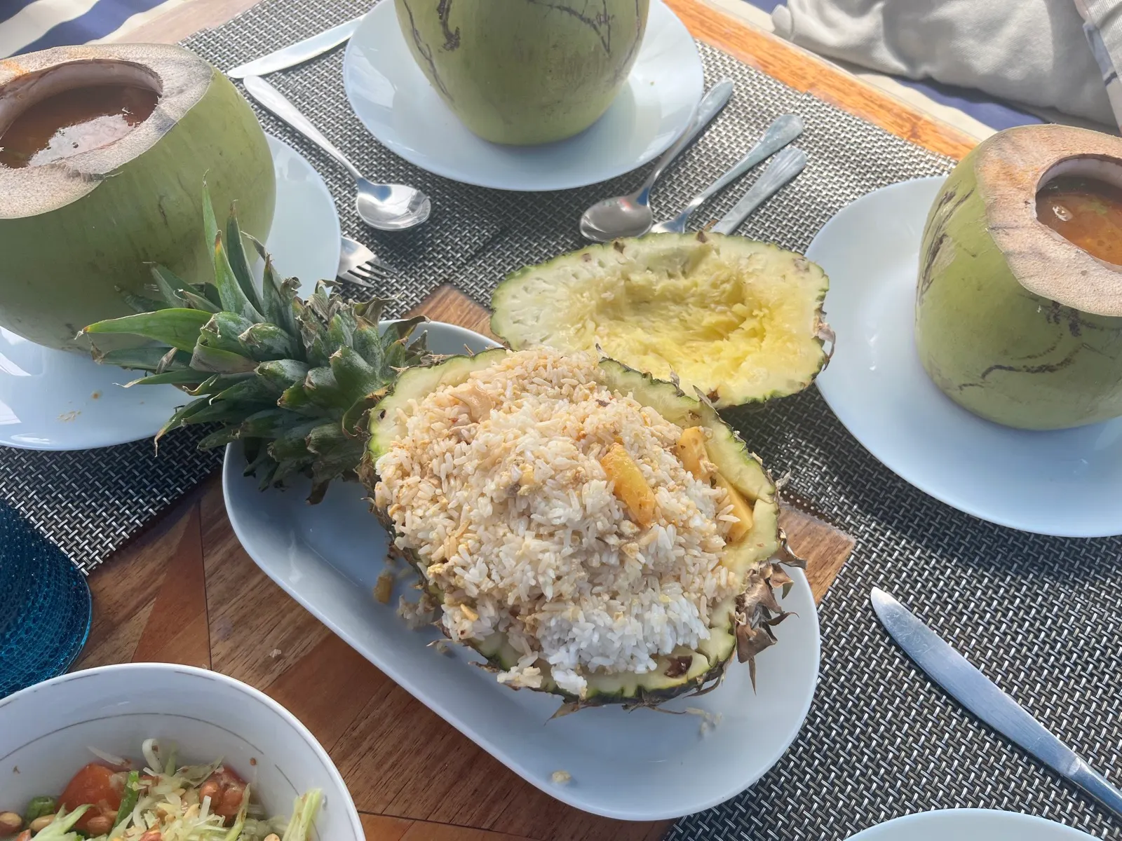 Coconuts and pineapple fried rice spread on table
