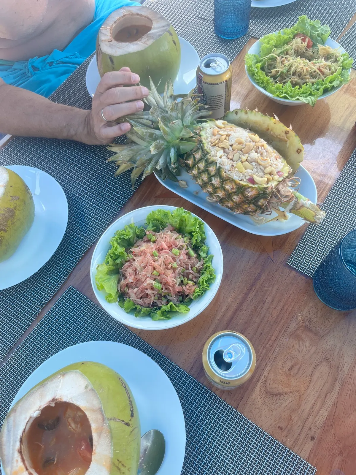 Pineapple rice, salads, coconuts, drinks close-up