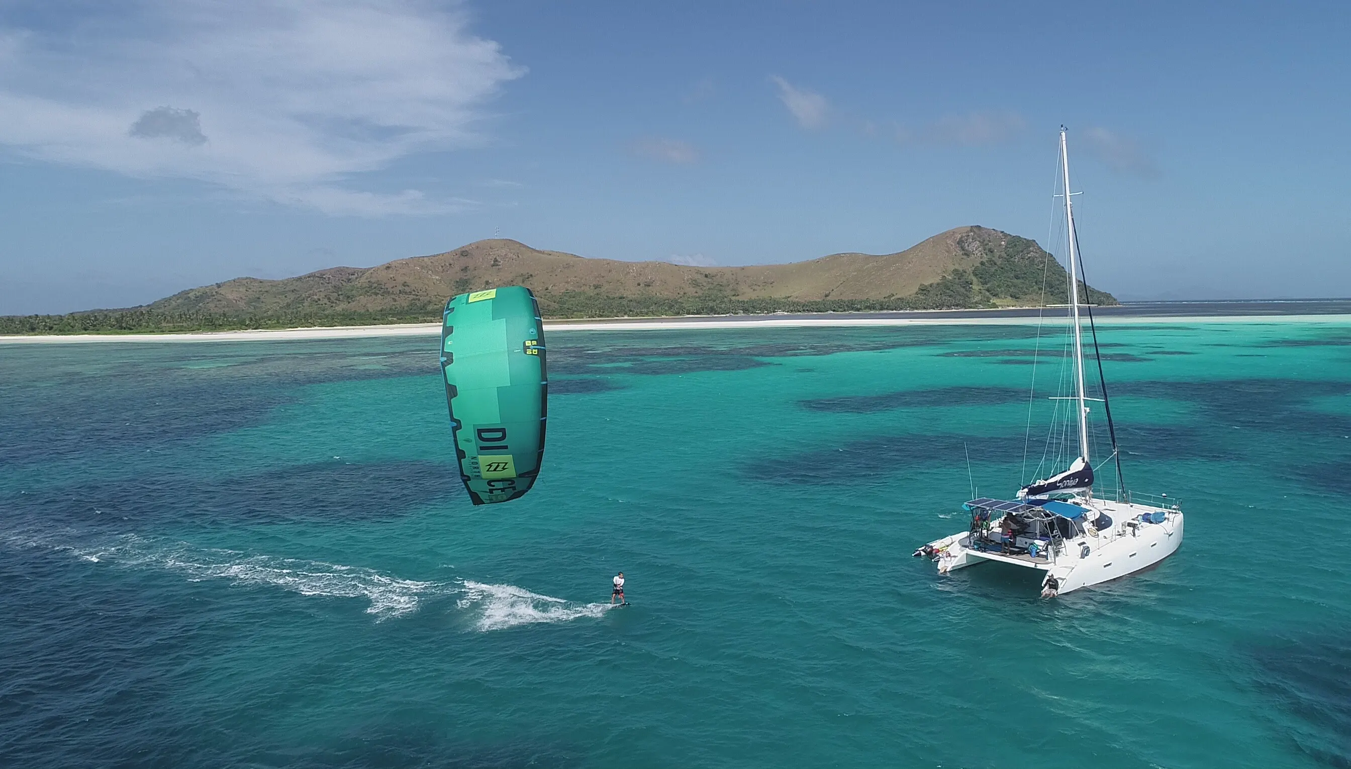 Aerial view of a heart-shaped reef around a small island