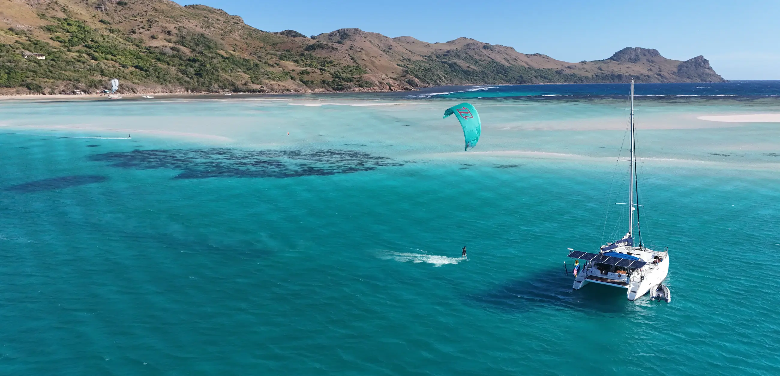 Soniya catamaran anchored in turquoise lagoon waters, Philippines