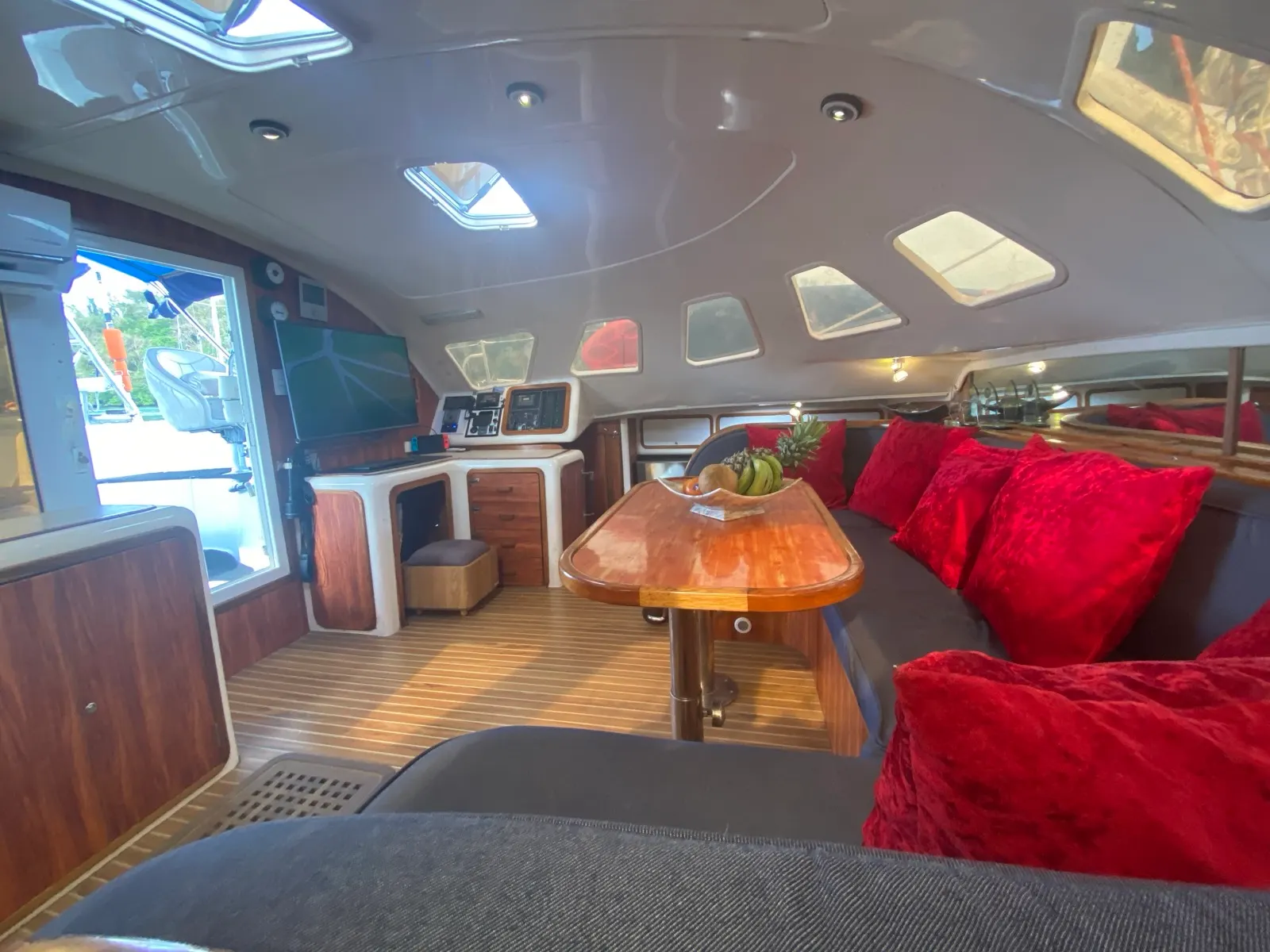 Indoor saloon lounge with red cushions, dining table set