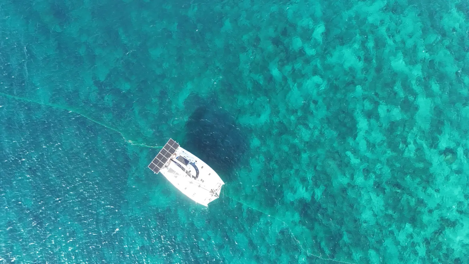 Close aerial of kitesurfer and kite over reef