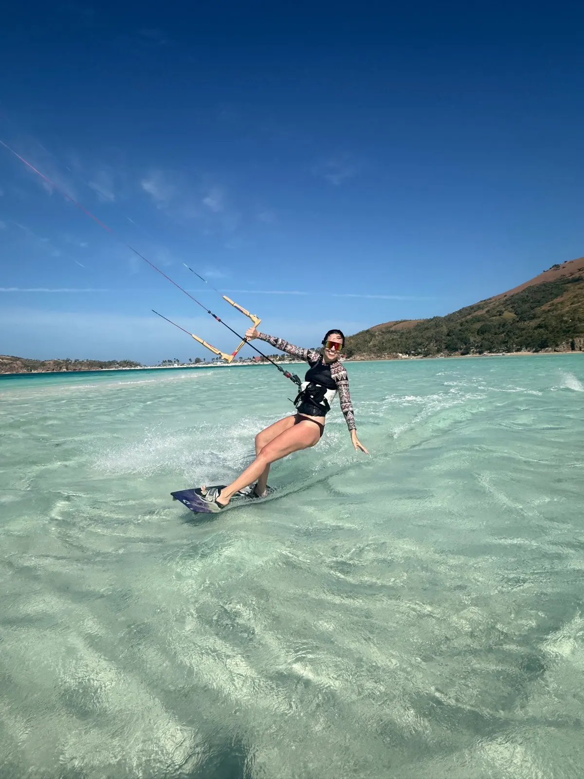 Woman kiteboarding in dynamic riding pose