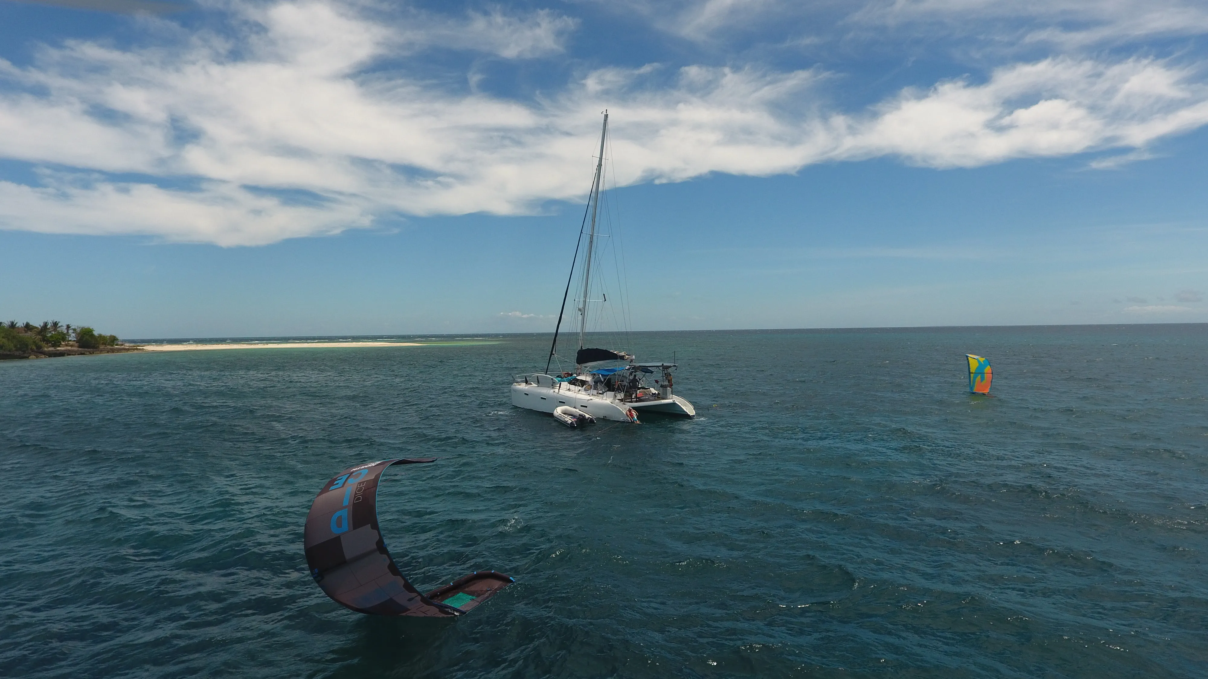 Aerial view of a Mindoro atoll island with kitesurfers on both sides