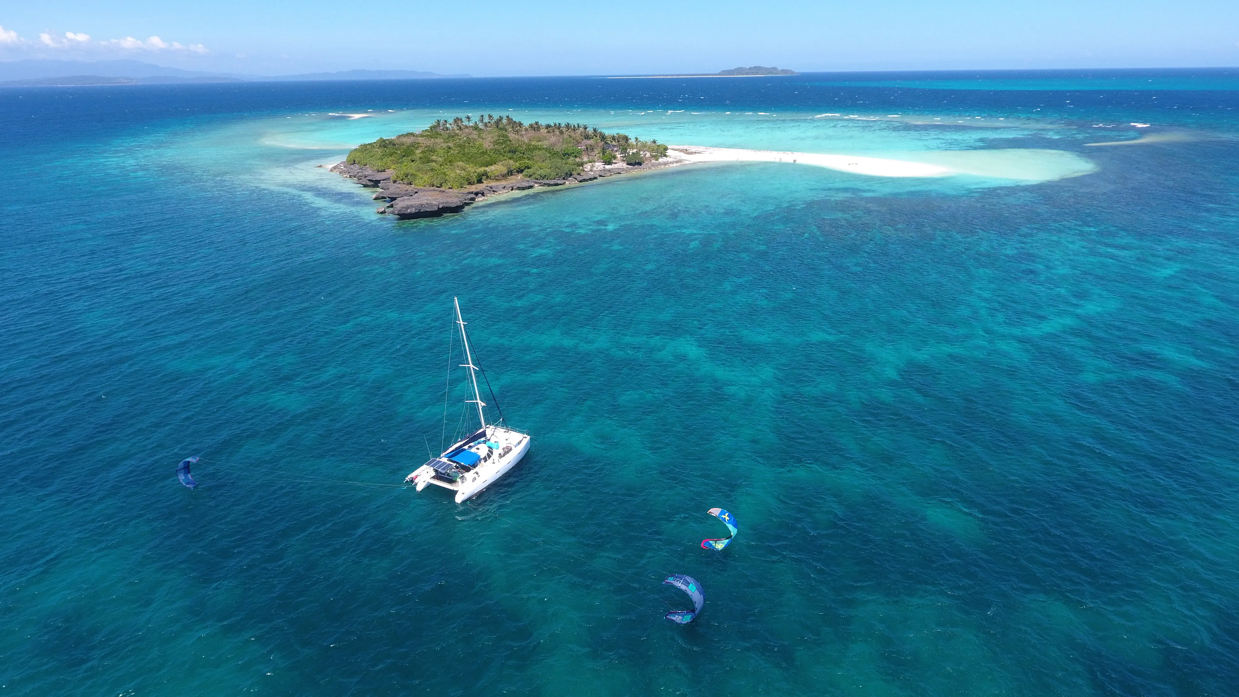 Aerial view of Soniya anchored near Mindoro with two kites flying nearby
