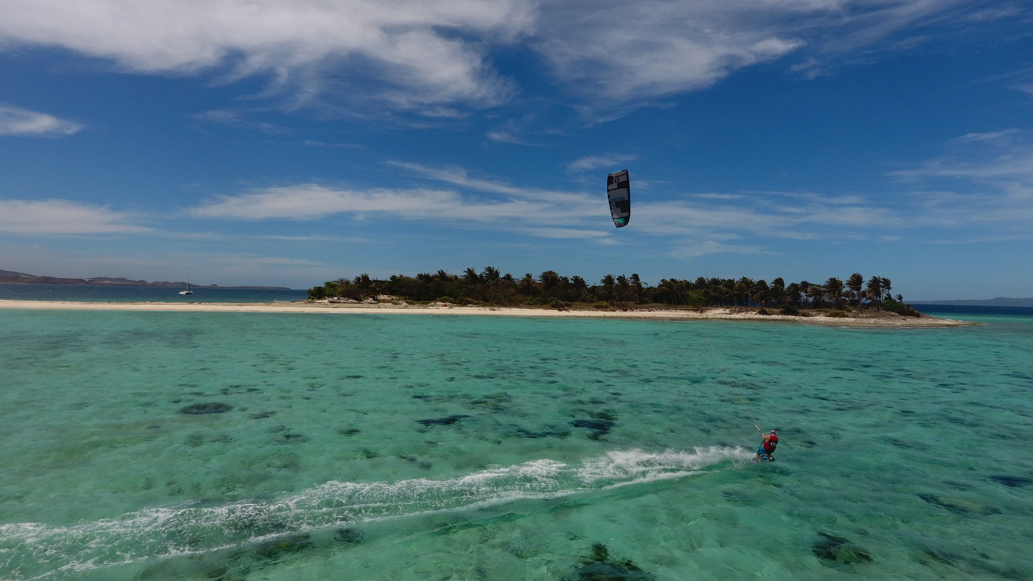 Close-up action shot of a kitesurfer riding near Mindoro