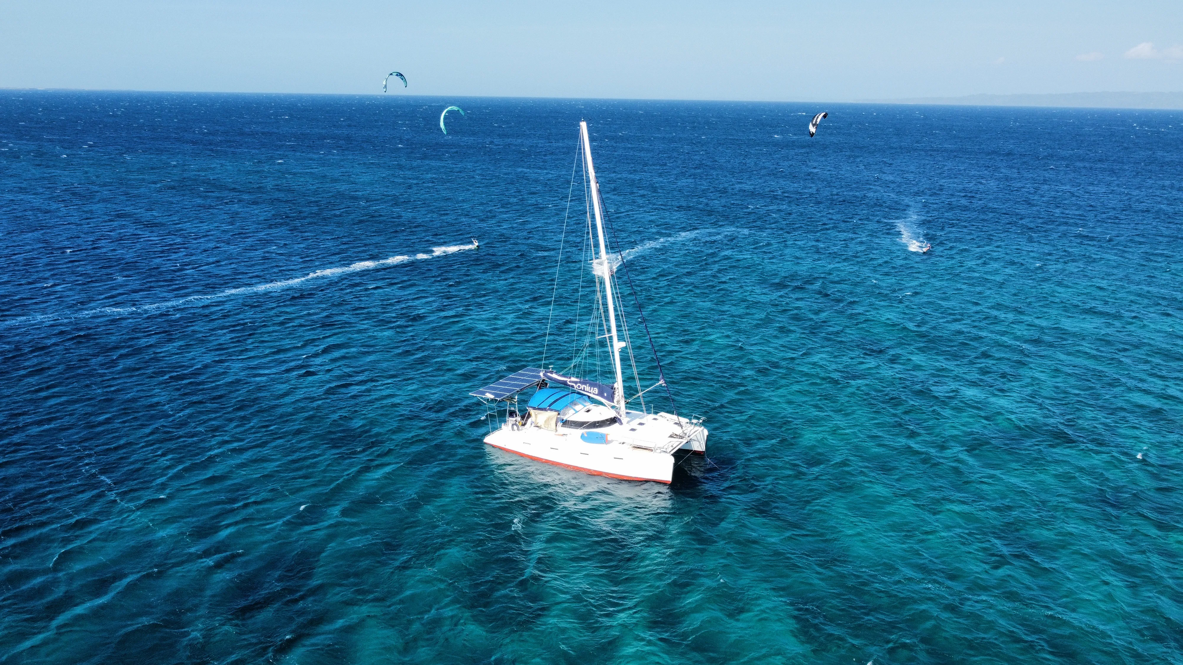 Aerial view of multiple kitesurfers flying near Soniya off Mindoro