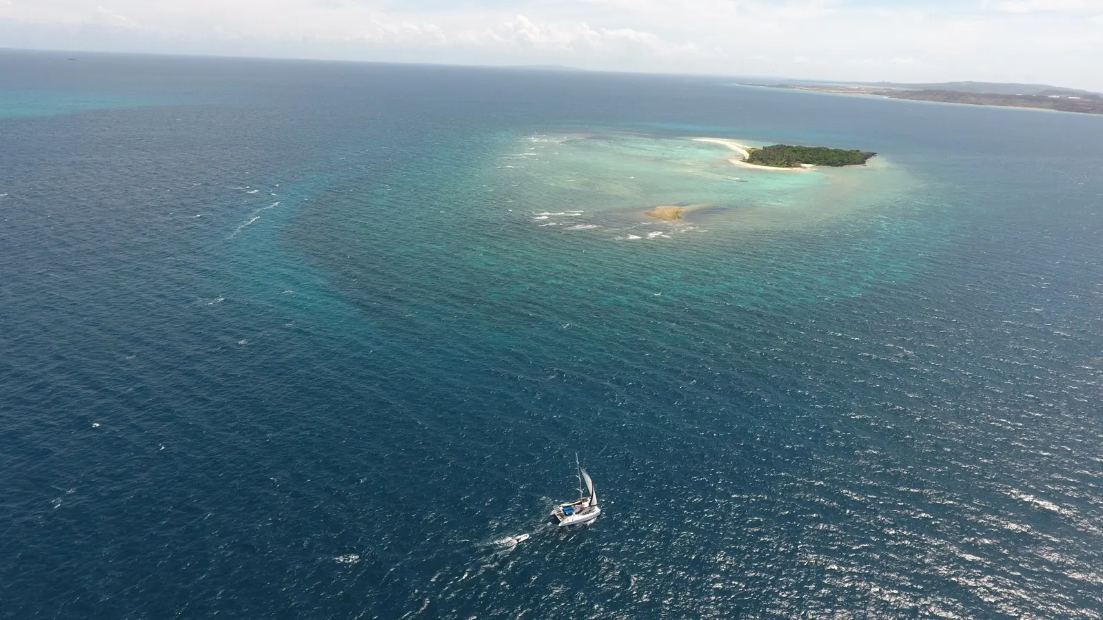 Soniya sailing toward a small reef island