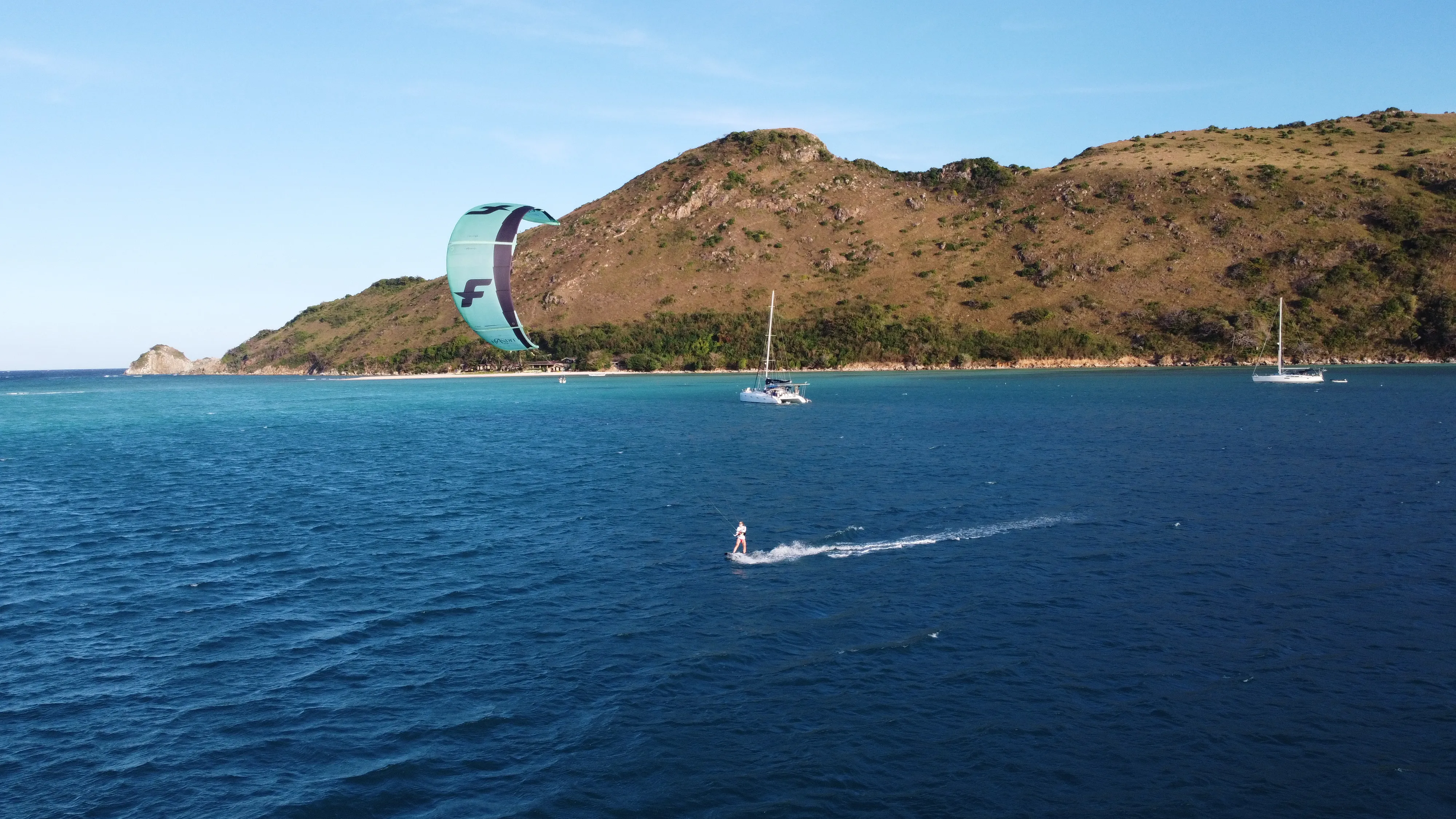 Aerial view of Soniya anchored with a group of riders near a Palawan island