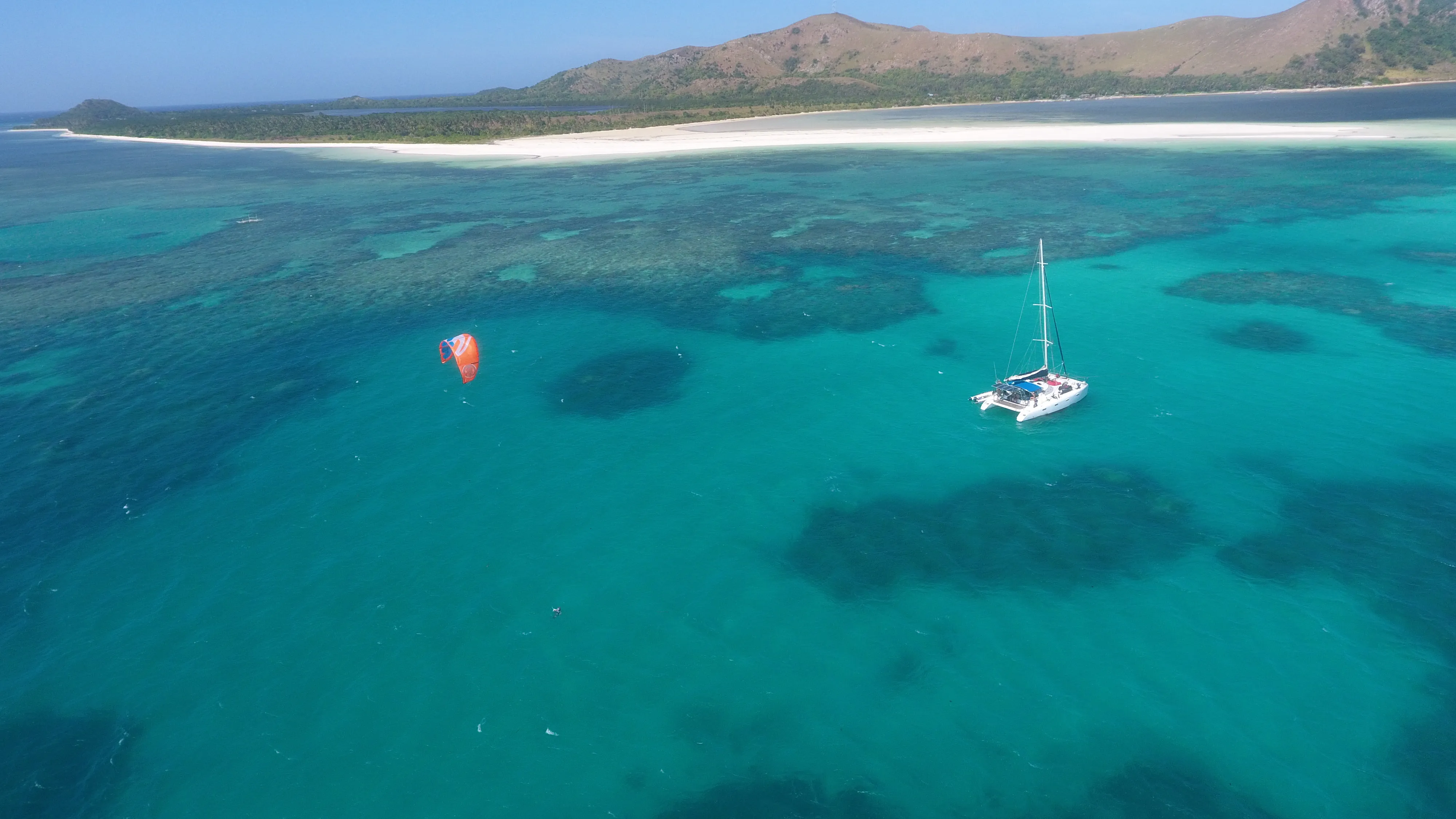 Aerial view of Soniya anchored with a kite flying nearby off Palawan