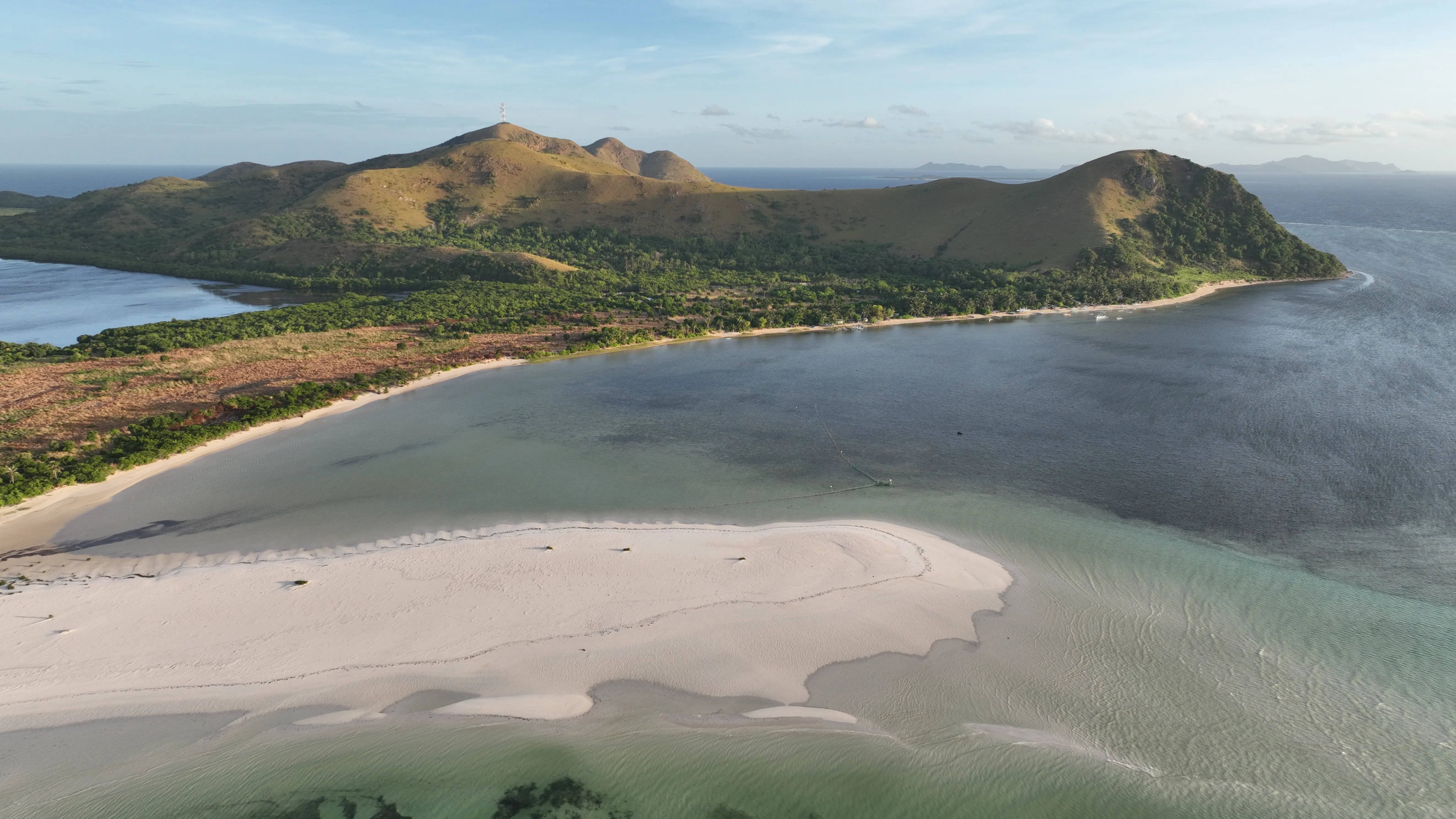 Wide aerial view of an island and lagoon along the Palawan route