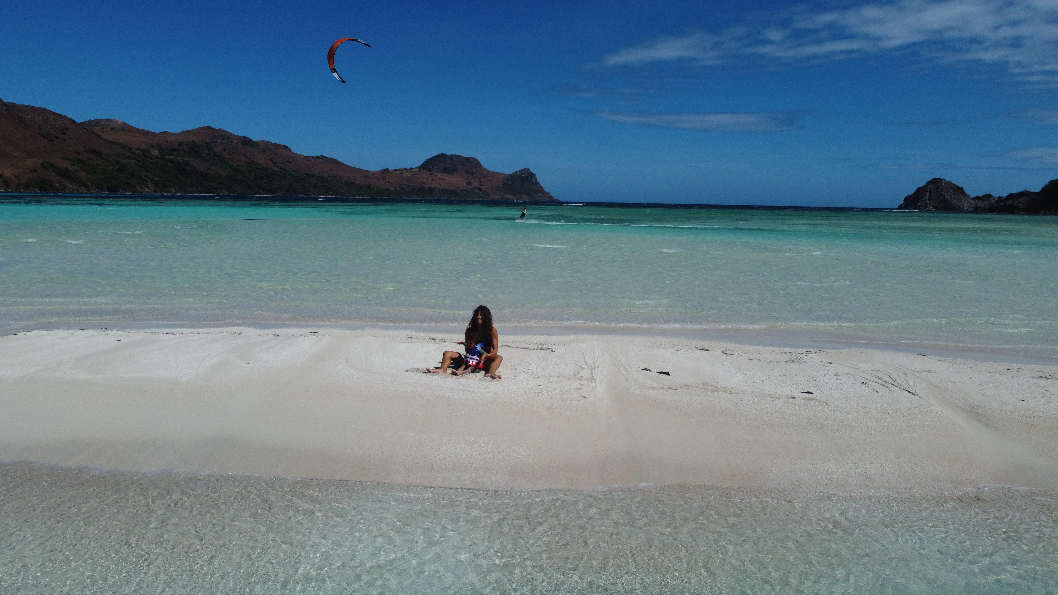 Aerial view of a lone figure on a remote Palawan sandbar