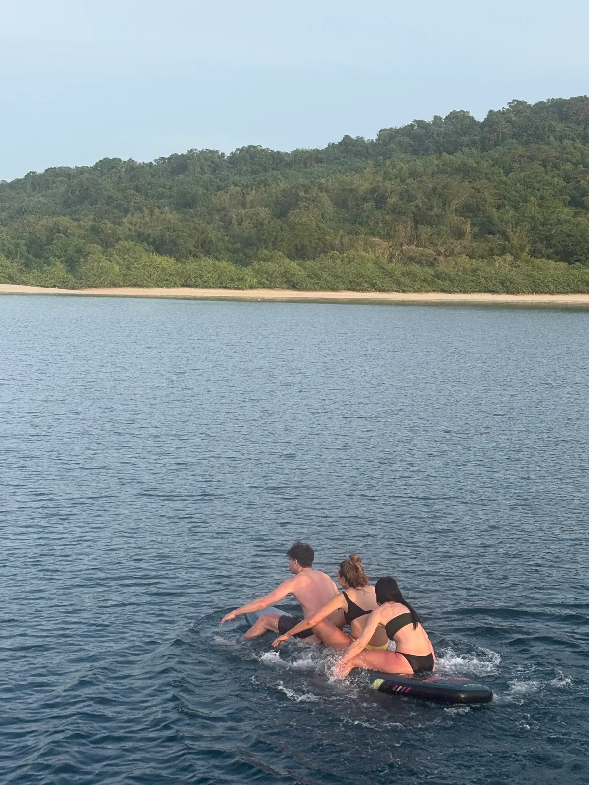 Group tumbling together off paddleboard into water