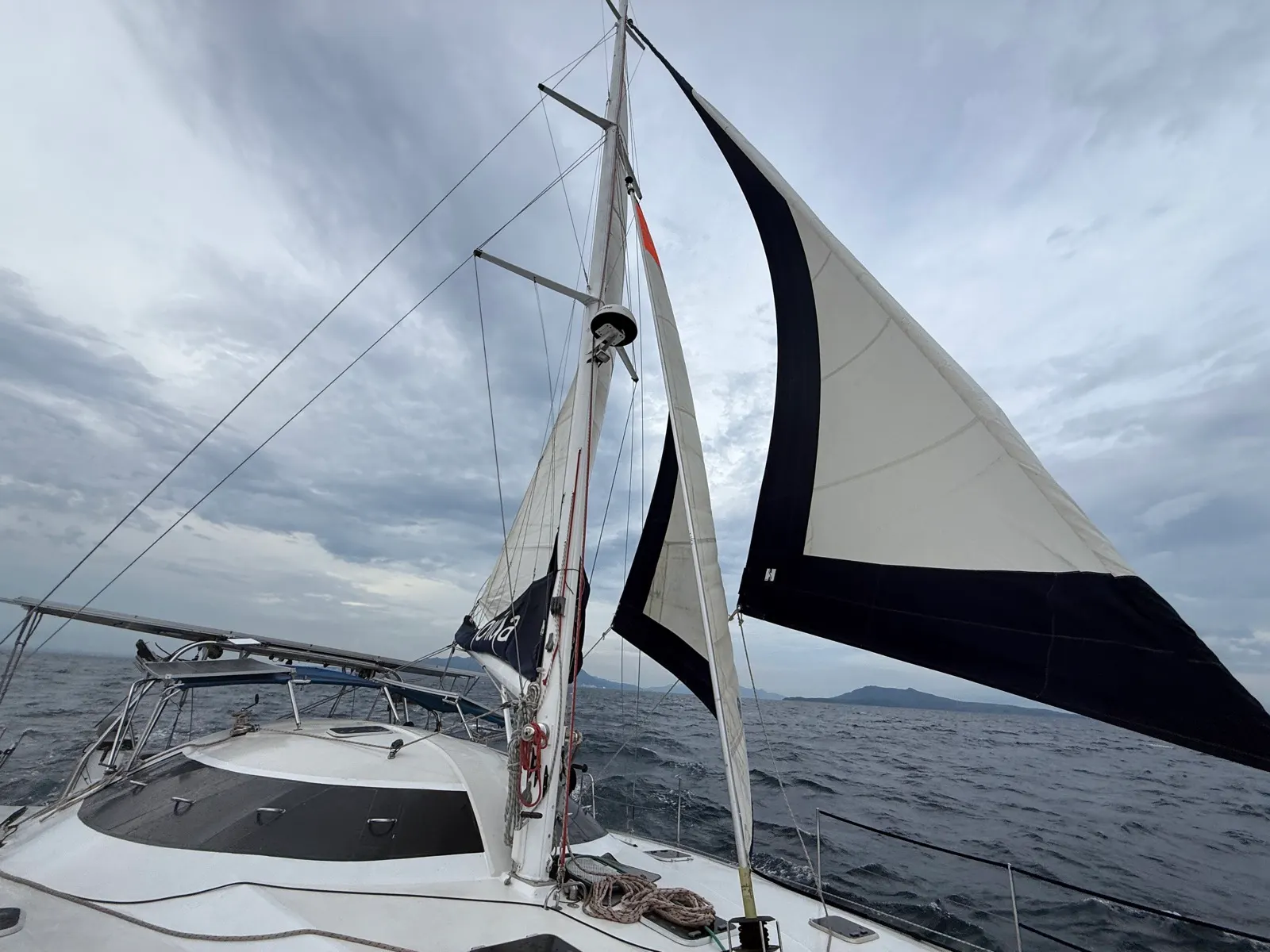 Multiple sails set under moody grey sky