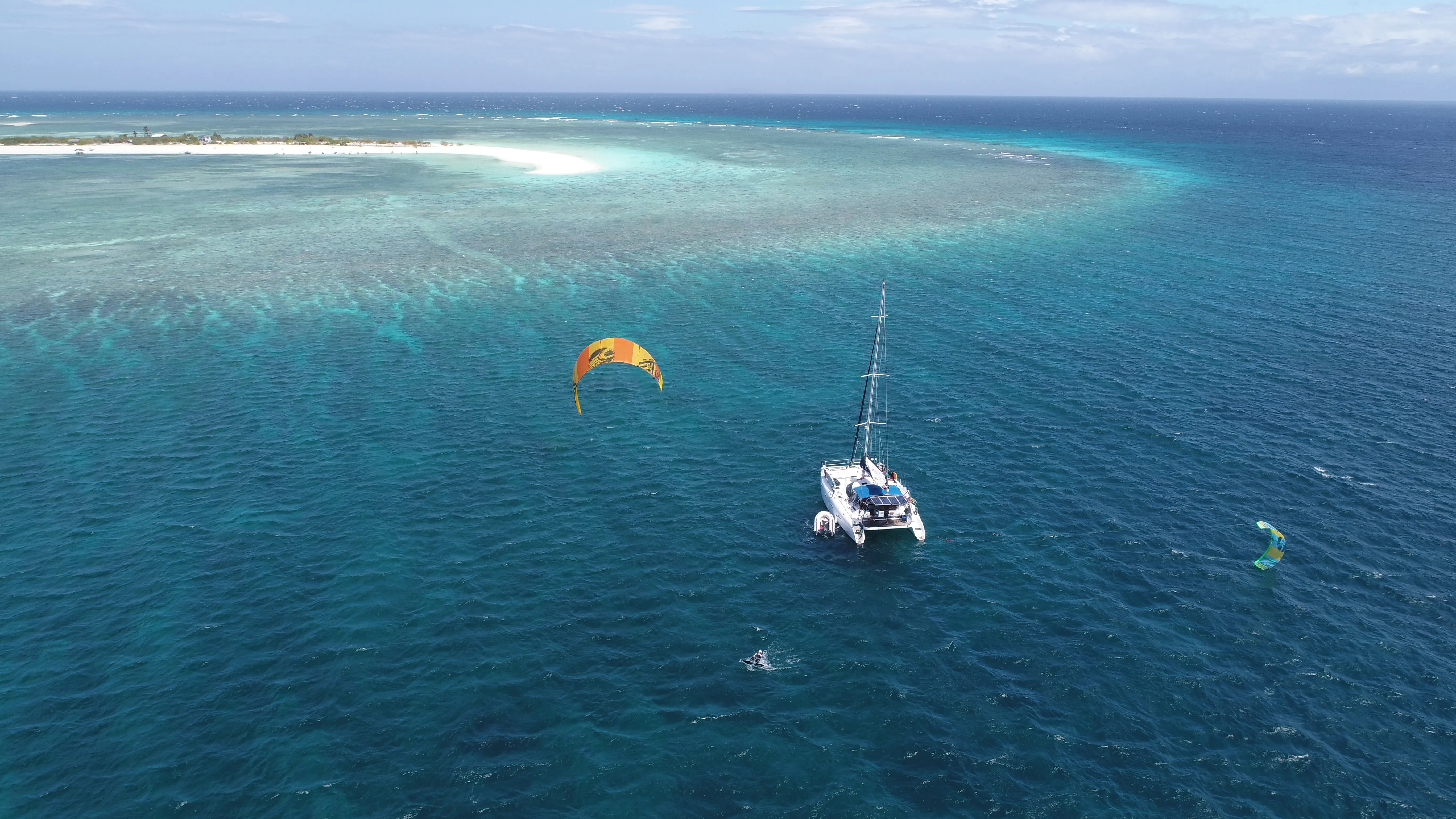 Soniya anchored off Seco Island's reef with a kitesurfer nearby