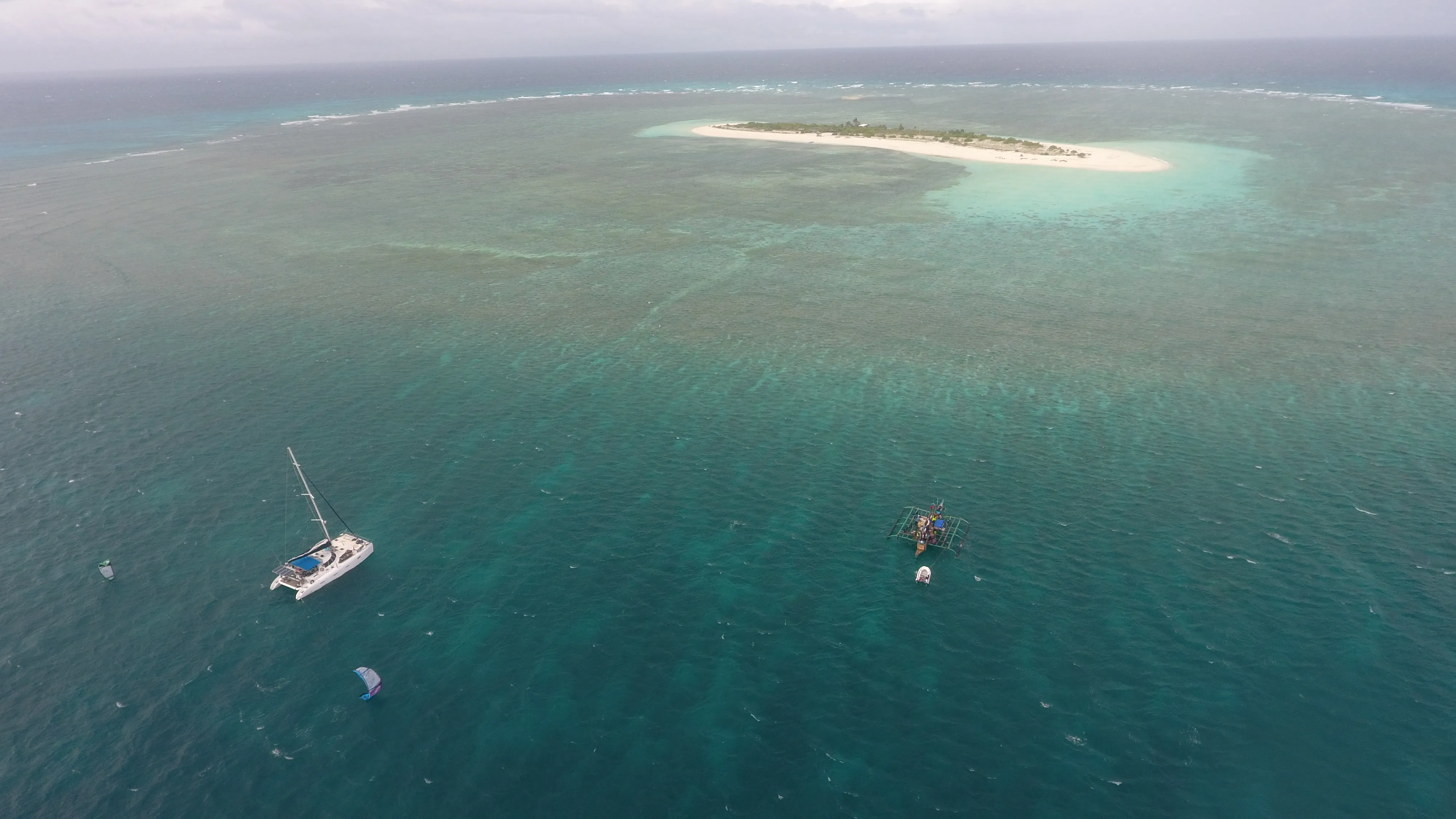 Wide aerial of Soniya anchored beside Seco Island's sandbar