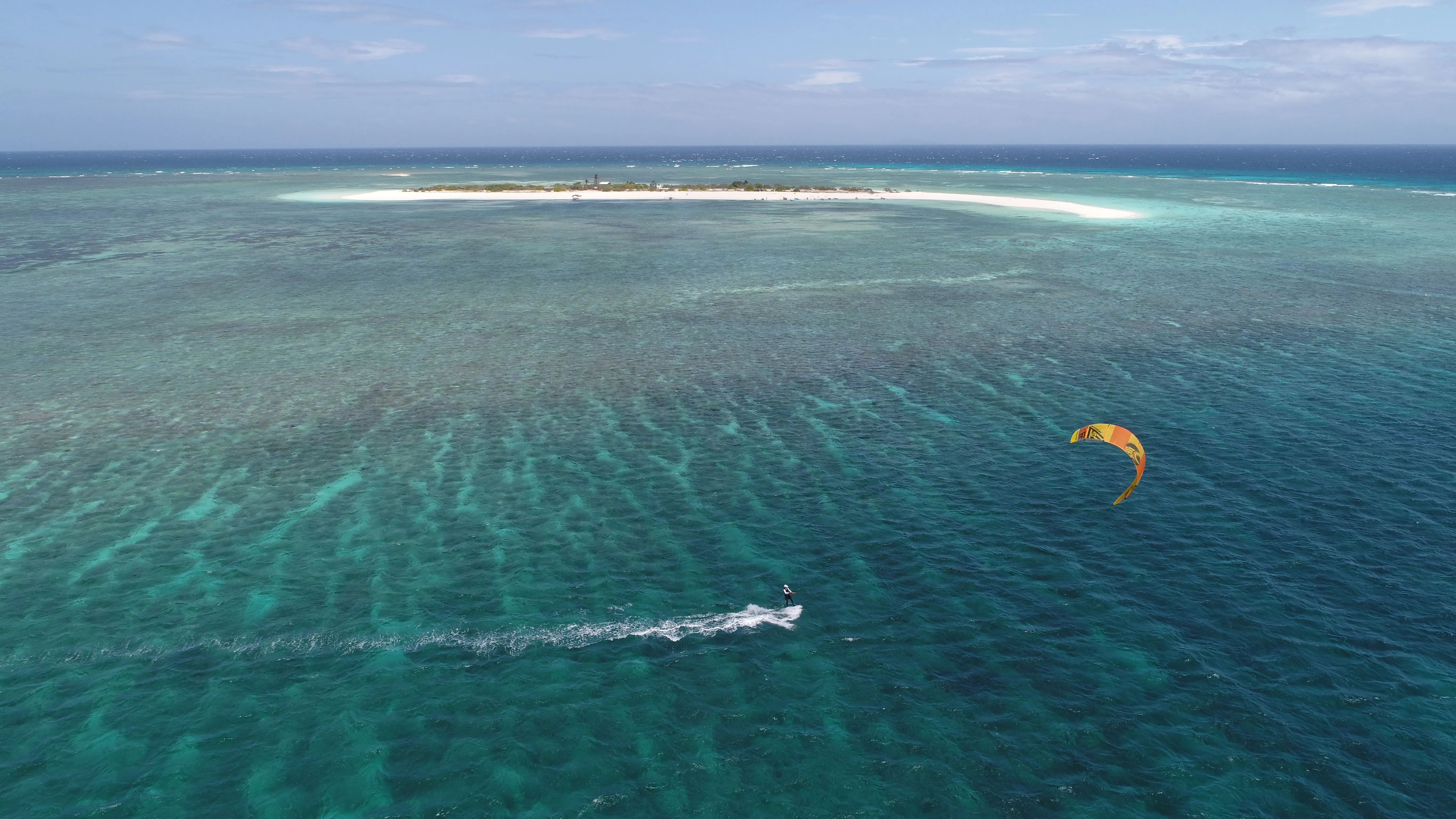 Aerial view of a kitesurfer riding near Seco Island