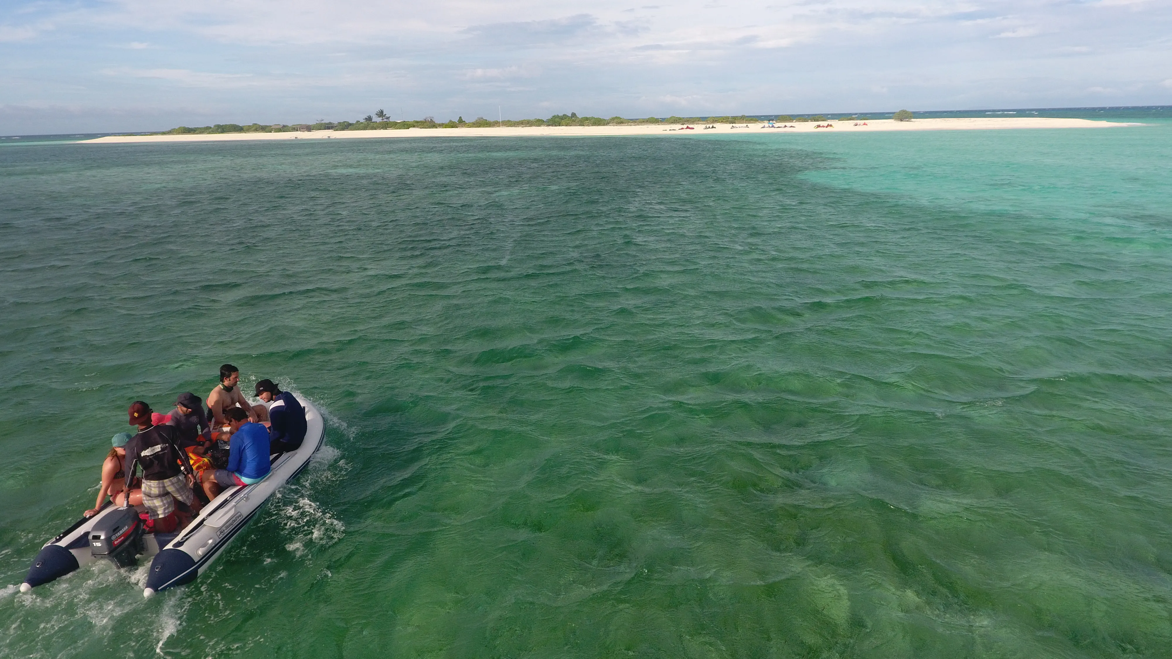 Dinghy full of guests approaching Seco Island's sandbar