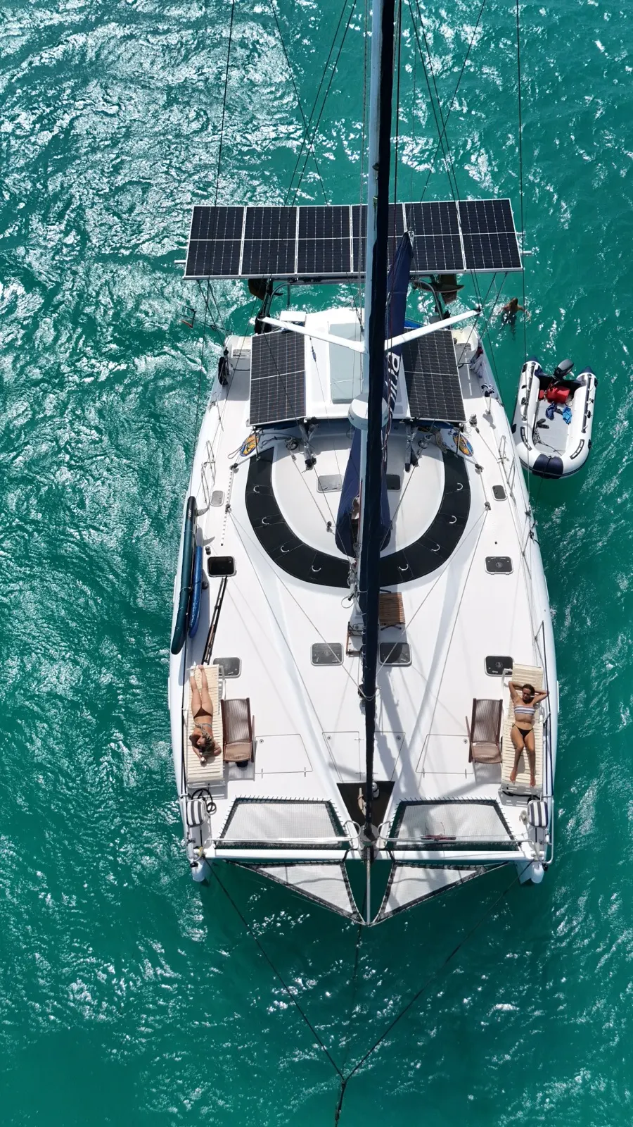 Aerial drone-selfie, two women sunbathing on bow nets
