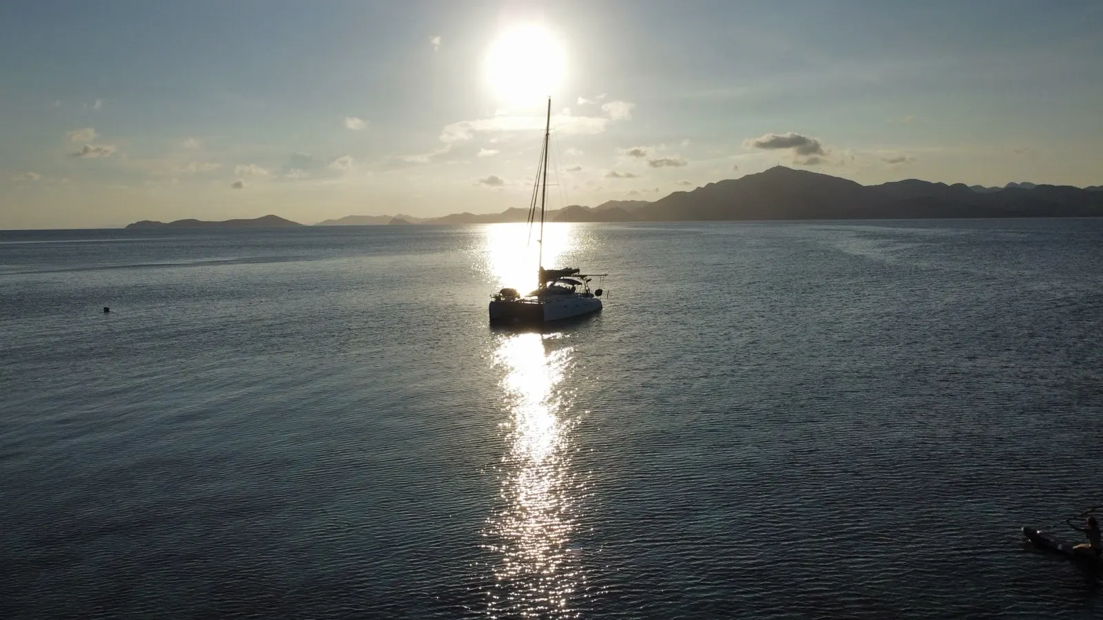 Golden sunset silhouette of catamaran
