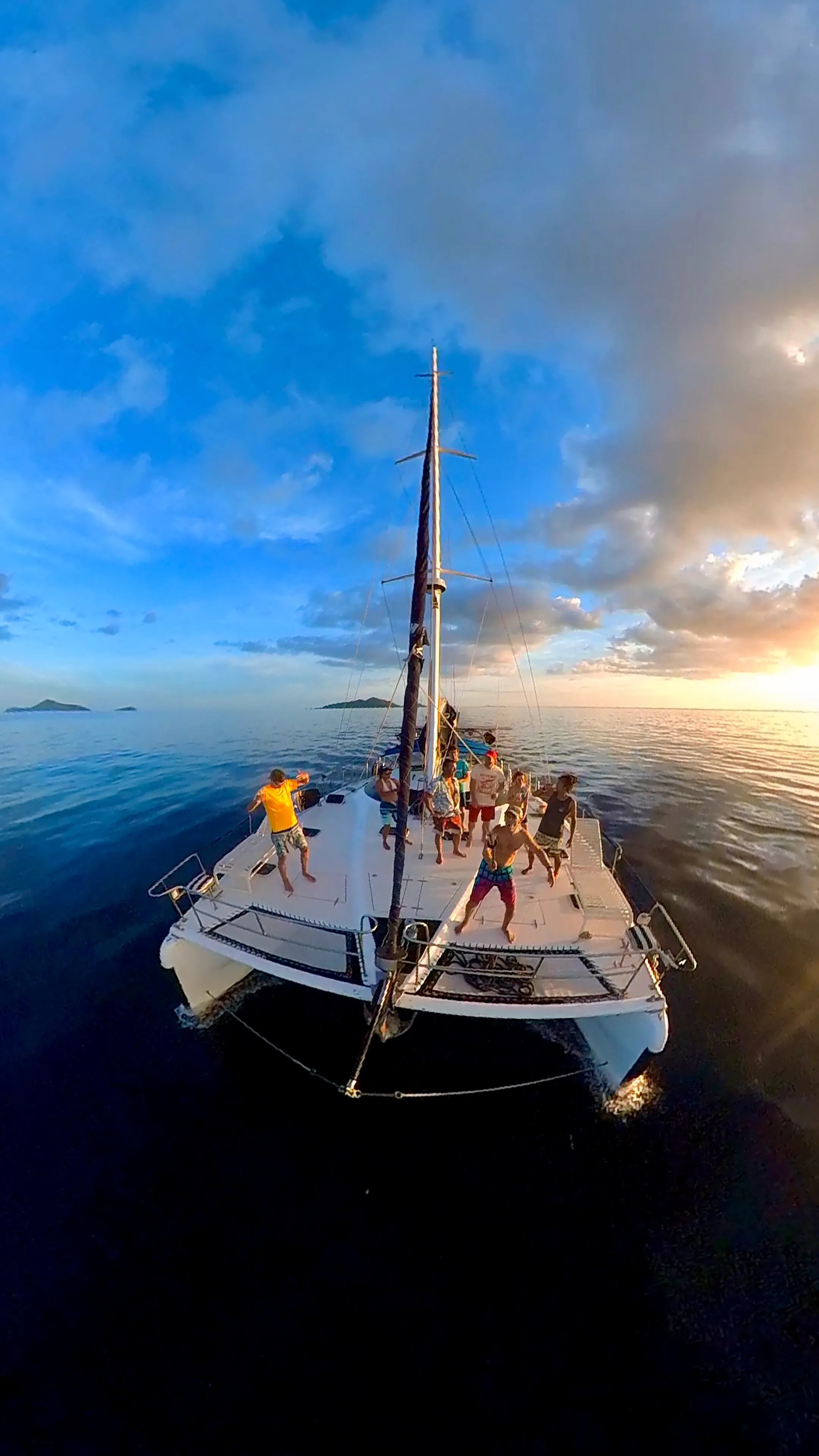 Guests dancing on deck at sunset