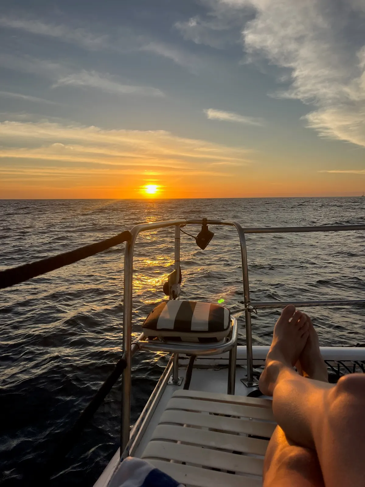 Feet up watching sunset over the ocean from deck